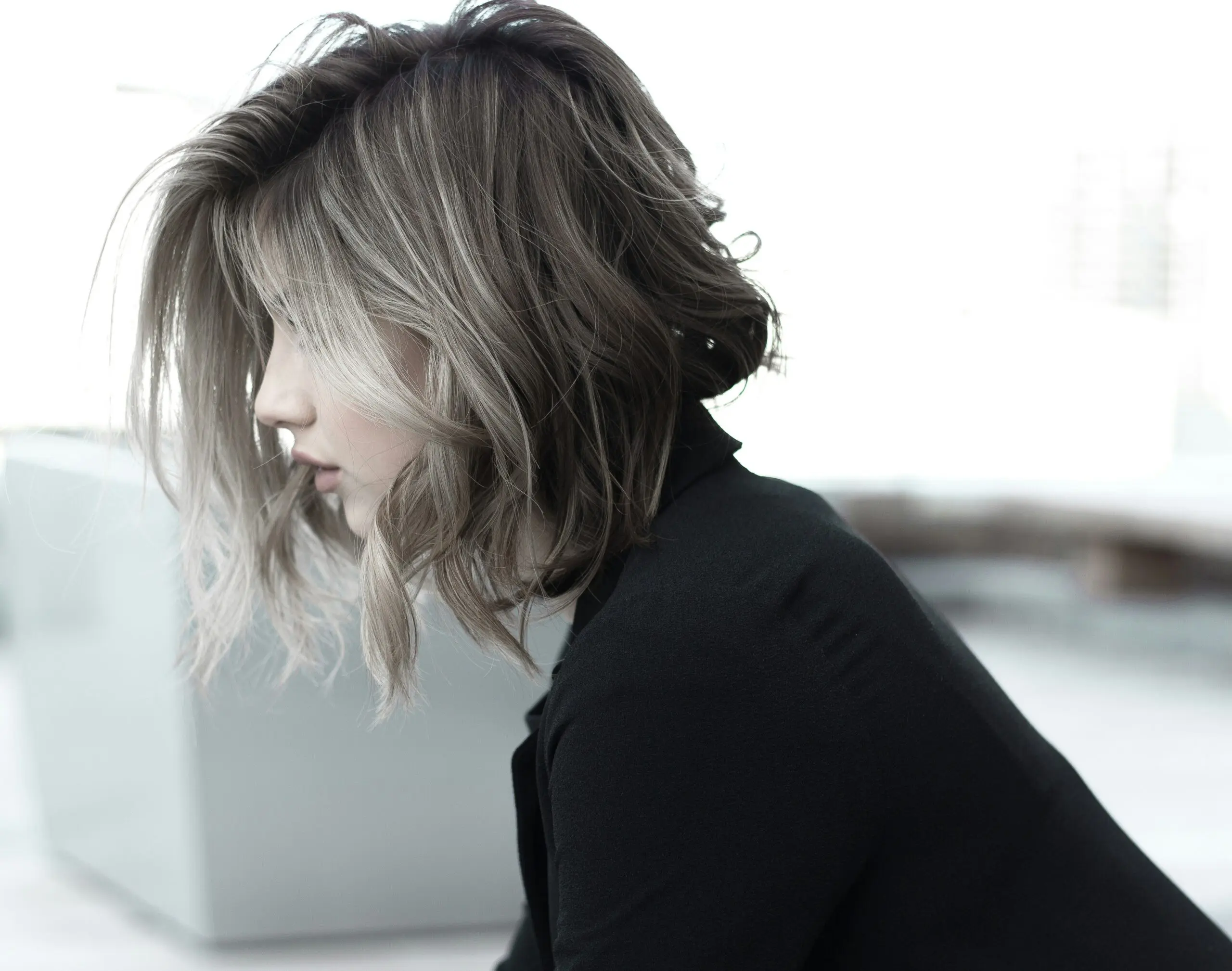Woman with high volume hair sitting outside